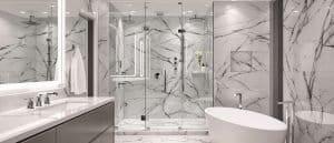 A luxurious marble bathroom in New Westminster, BC, featuring a freestanding bathtub, a glass-enclosed double rain shower, and a sleek vanity with an LED-lit mirror.