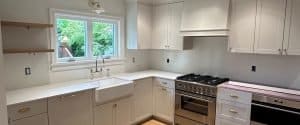 modern white kitchen with sink and stove area | GPS: 49.411157, -122.848865